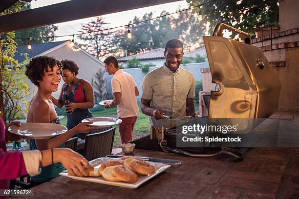 hipsters grilling at a summer backyard bbq - international labour day bildbanksfoton och bilder