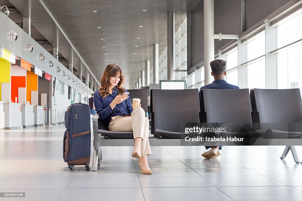 Woman waiting for flight at the airport lounge