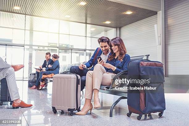 people waiting for flight at airport lounge - couple traveler stock pictures, royalty-free photos & images