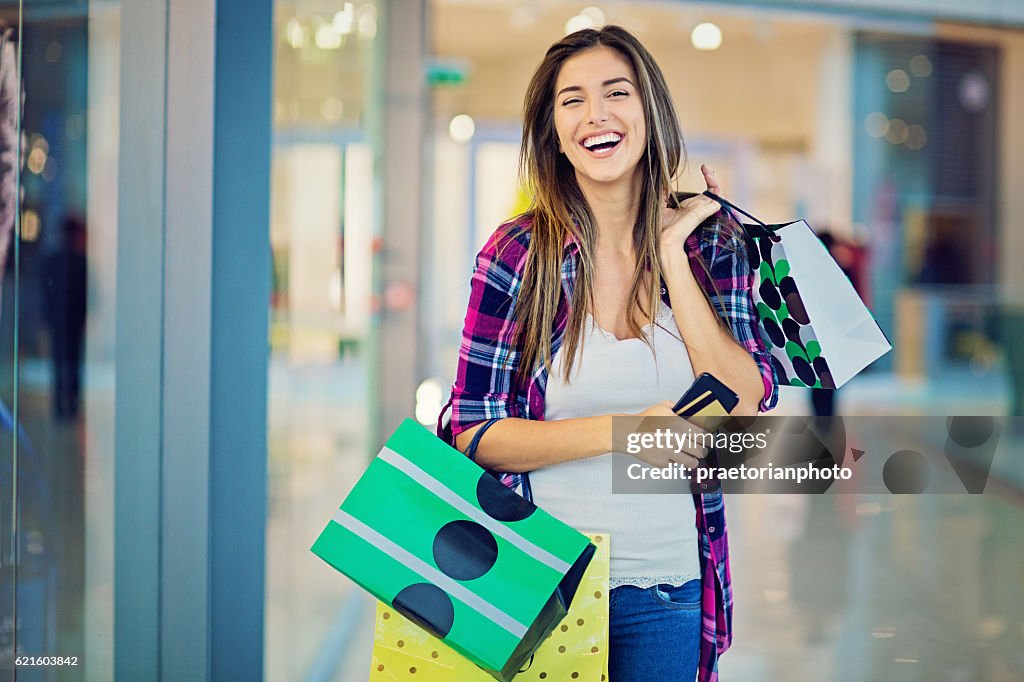 Young beautiful girl is shopping in the Mall