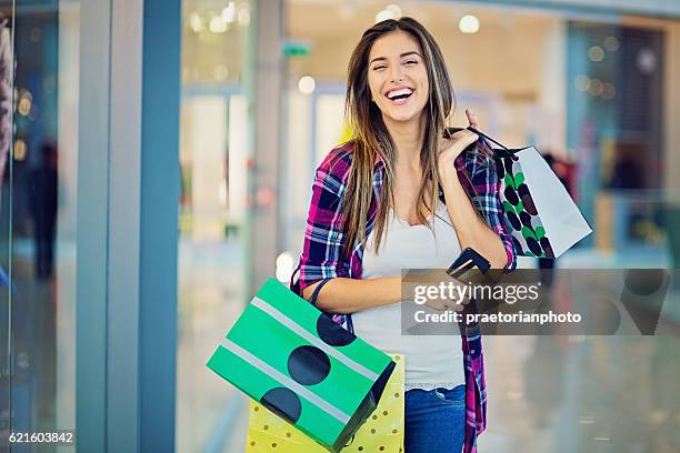 young beautiful girl is shopping in the mall - girl after shopping stock pictures, royalty-free photos & images