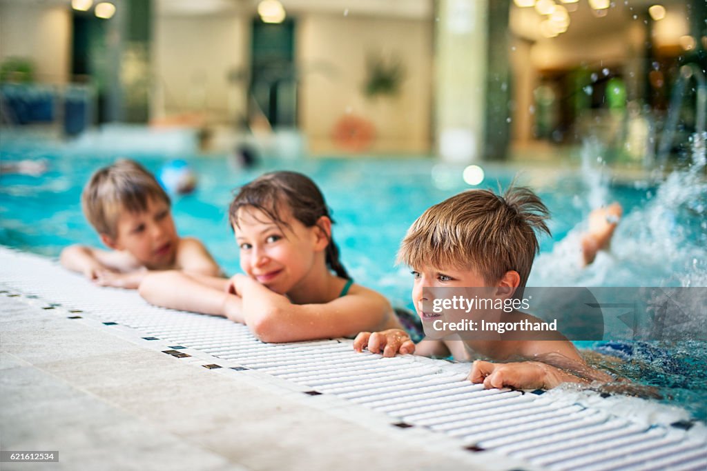 Kids learning to swim in indoors swimming pool