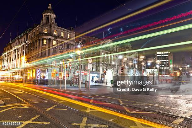 dublin street tram long exposure - o'connell street stock pictures, royalty-free photos & images