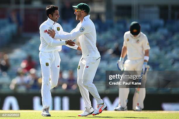 Faf du Plessis and Keshav Maharaj of South Africa celebrate after defeating Australia during day five of the First Test match between Australia and...