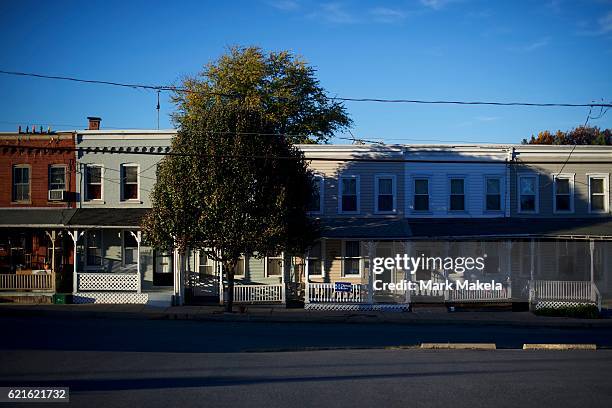 Boy cycles past a home with a Hillary Clinton yard sign November 5, 2016 in Lancaster, Pennsyvalnia. Polls have narrowed in the final days of the...