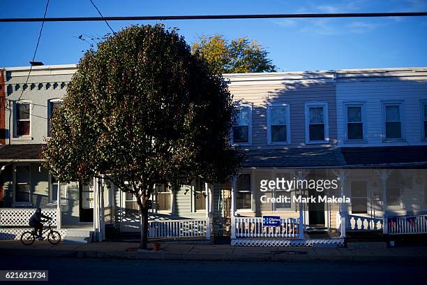 Boy cycles past a home with a Hillary Clinton yard sign November 5, 2016 in Lancaster, Pennsyvalnia. Polls have narrowed in the final days of the...