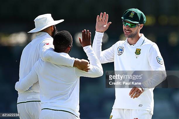 Hashim Amla and Stephen Cook of South Africa celebrate with Temba Bavuma after dismissing Josh Hazlewood of Australia during day five of the First...