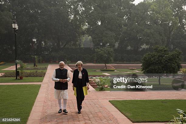 British Prime Minister Theresa May and Indian Prime Minister Narendra Modi walk through the gardens of Hyderabad House, on November 7, 2016 in New...