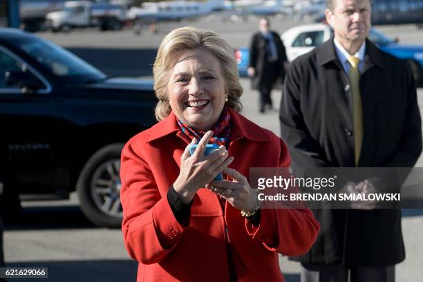 Democratic presidential nominee Hillary Clinton smiles after using her phone to video chat with her granddaughter Charlotte Clinton Mezvinsky before...