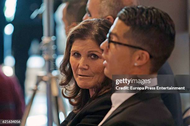 Real Madrid football player Cristiano Ronaldo is joined by his mother Maria Dolores dos Santos Aveiro following his press conference after signing a...