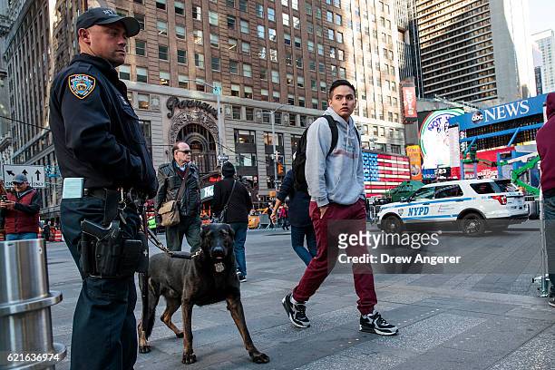 New York City Police officer and a bomb-sniffing dog patrol in Times Square, November 7, 2016 in New York City. With both presidential candidates...