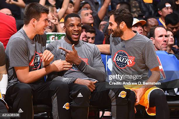 Ivica Zubac, Tarik Black and Jose Calderon of the Los Angeles Lakers smile and laugh on the bench against the Golden State Warriors on November 4,...