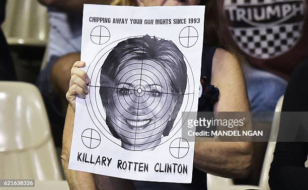 Supporter holds a target with the face of Democratic presidential nominee Hillary Clinton on it at a rally for Republican presidential nominee Donald...
