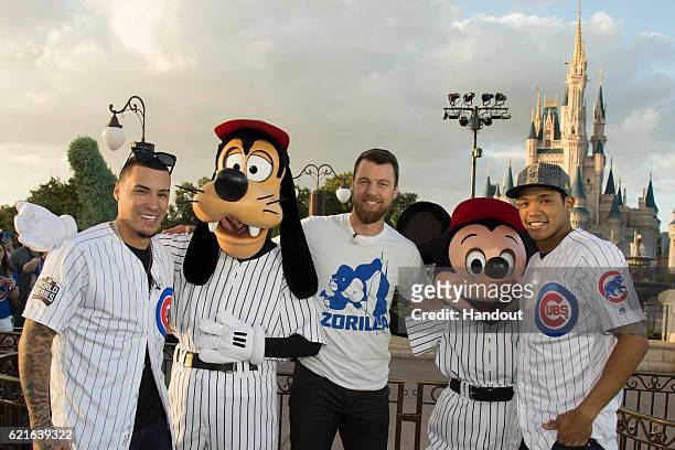 In this handout photo provided by Disney Parks, world champions Javier Baez, MVP Ben Zobrist and Addison Russell, of the Chicago Cubs, pose for a...