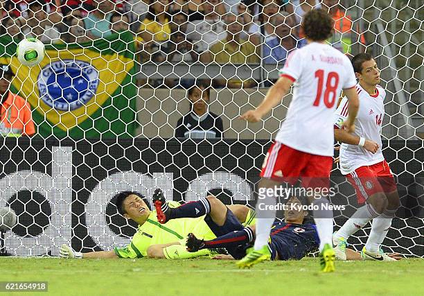 Brazil - Mexico's Javier Hernandez scores his second goal past Japan goalkeeper Eiji Kawashima and Atsuto Uchida in the 66th minute of a...