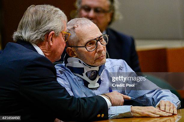 Lawyer Dick DeGuerin, left, talks with real estate heir Robert Durst in the Airport Branch of the Los Angeles County Superior Court on November 7,...