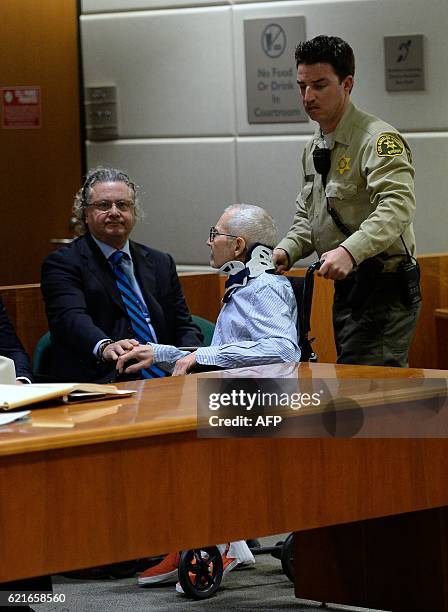 Lawyer David Chesnoff touches the hand of New York real estate heir Robert Durst on arrival for his trial at the Airport Branch of the Los Angeles...