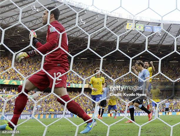 Brazil - Uruguay's Diego Forlan sees his penalty saved by Brazilian goalkeeper Julio Cesar during the first half of a Confederations Cup semifinal in...
