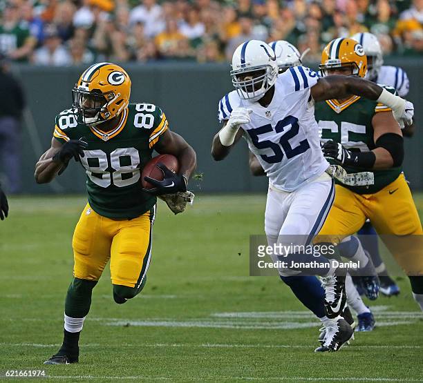 Ty Montgomery of the Green Bay Packers runs for a first down chased by D'Qwell Jackson of the Indianapolis Colts at Lambeau Field on November 6, 2016...
