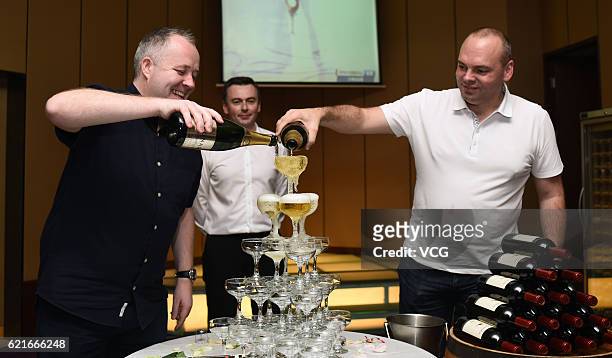 John Higgins of Scotland and Stuart Bingham of England attend the celebration party after the final match of of the Evergrande China Championship at...
