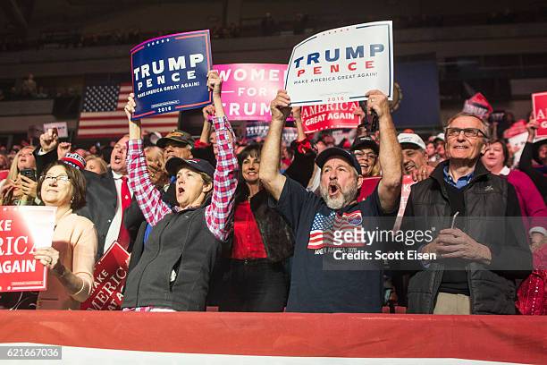 Supporters of Republican Presidential nominee Donald J. Trump cheer as Governor Mike Pence takes the stage during a rally at the SNHU Arena on...
