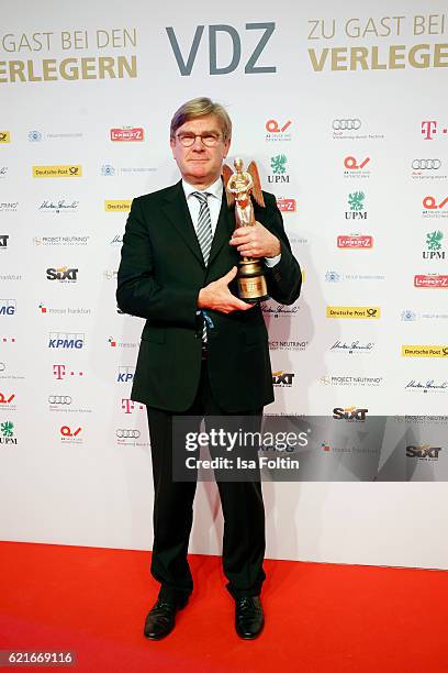 Michael Kleinemeier poses with the "Entrepreneur of the year" prize during the VDZ Publishers' Night 2016 at Deutsche Telekom's representative office...