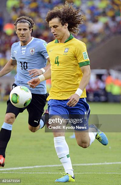 Brazil - Brazilian defender David Luiz keeps the ball during a Confederations Cup semifinal against Uruguay in Belo Horizonte, Brazil, on June 26,...