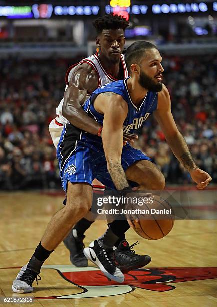 Jimmy Butler of the Chicago Bulls gets his arm around Evan Fournier of the Orlando Magic at the United Center on November 7, 2016 in Chicago,...