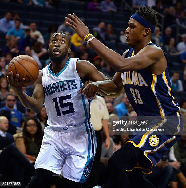 Charlotte Hornets guard Kemba Walker, left, drives to the basket against Indiana Pacers center Myles Turner, right, during the first half on Monday,...