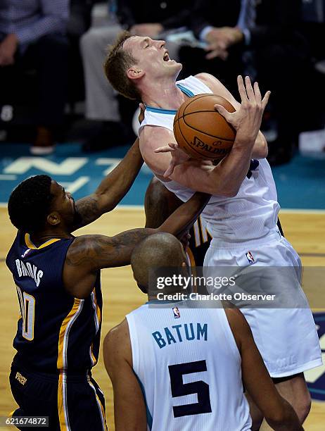 Charlotte Hornets forward/center Cody Zeller, right, is fouled on a drive to the basket by Indiana Pacers guard Aaron Brooks, left, during the second...