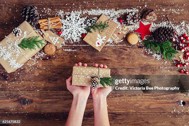 creative hobby. girl's hands show christmas holiday handmade present in craft paper - seville christmas stock pictures, royalty-free photos & images