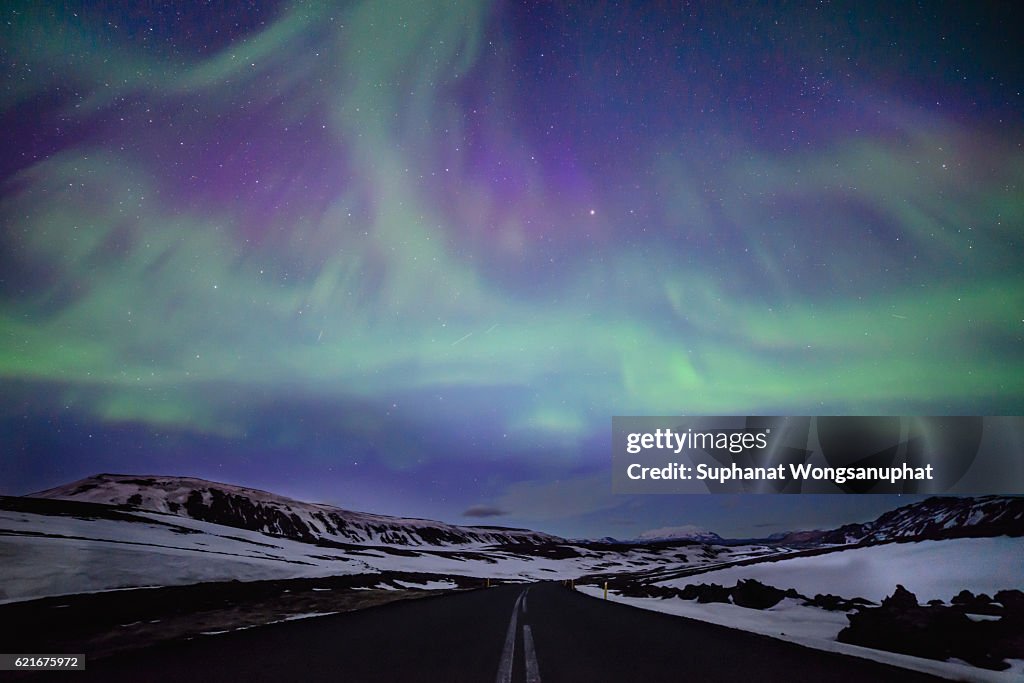 Northern lights over distant mountains in Iceland