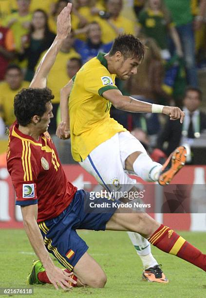 Brazil - Brazil's Neymar scores the team's second goal just before halftime in the Confederations Cup final against Spain in Rio de Janeiro, Brazil,...