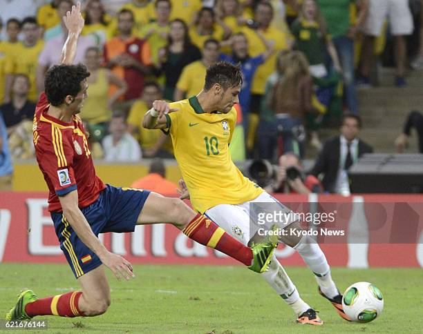 Brazil - Brazil's Neymar scores the team's second goal just before halftime in the Confederations Cup final against Spain in Rio de Janeiro, Brazil,...