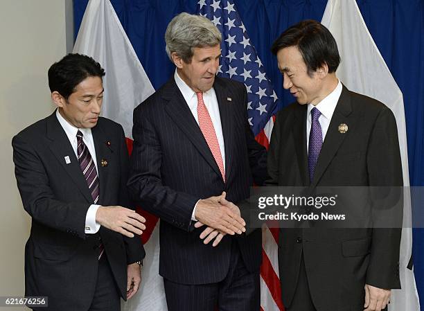 Brunei - Japanese Foreign Minister Fumio Kishida, U.S. Secretary of State John Kerry and South Korean Foreign Minister Yun Byung Se shake hands prior...