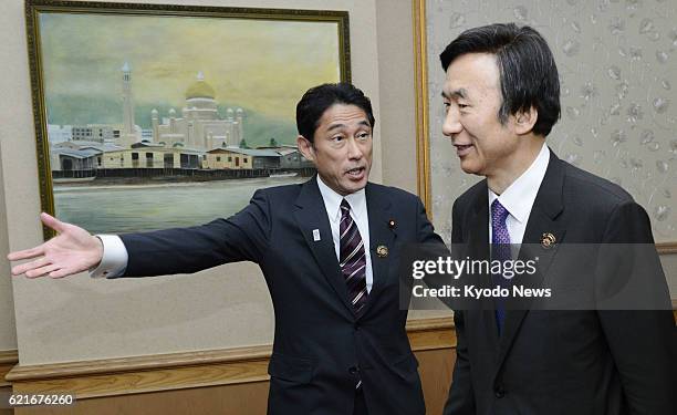 Brunei - Japanese Foreign Minister Fumio Kishida leads the way prior to holding talks with his South Korean counterpart Yun Byung Se in Bandar Seri...