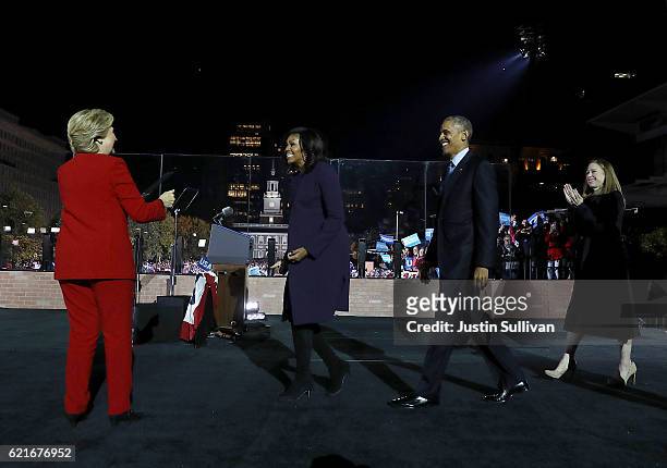 Democratic presidential nominee former Secretary of State Hillary Clinton is greeted by U.S First Lady Michelle Obama, U.S. President Barack Obama...