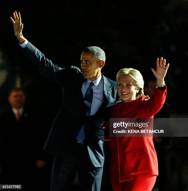 Democratic presidential nominee Hillary Clinton and US President Barack Obama wave to the crowd after a rally on Independence Mall in Philadelphia,...