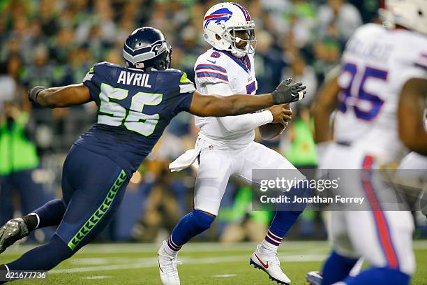 Quarterback Tyrod Taylor of the Buffalo Bills tries to evade defensive end Cliff Avril of the Seattle Seahawks at CenturyLink Field on November 7,...