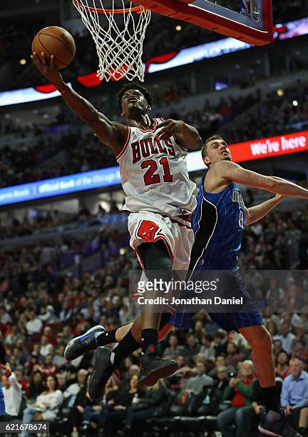 Jimmy Butler of the Chicago Bulls puts up a shot past Mario Hezonja of the Orlando Magic on his way to a game-high 20 points at the United Center on...