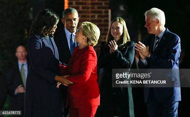Democratic presidential nominee Hillary Clinton stands with US President Barack Obama , First Lady Michelle Obama , former US president Bill Clinton...