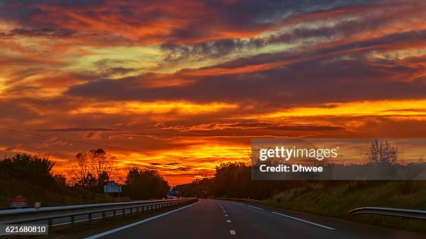 dramatic sunrise over highway - fast cover foto e immagini stock