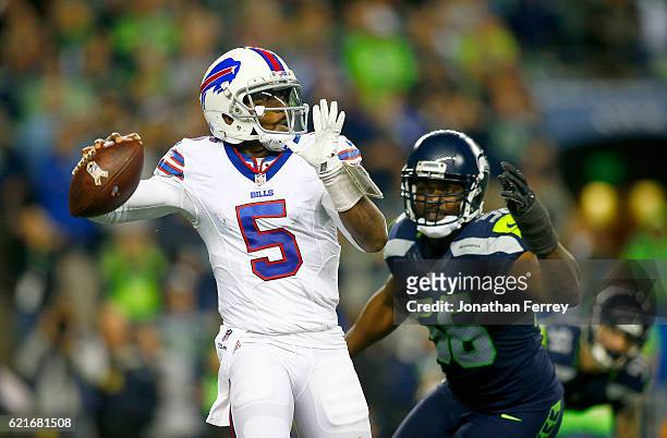 Quarterback Tyrod Taylor of the Buffalo Bills is pressured by defensive end Cliff Avril of the Seattle Seahawks at CenturyLink Field on November 7,...