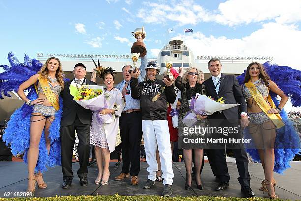 Driver Mark Purdon celebrates with owners of Lazarus after winning Race 10 the New Zealand Trotting Cup during New Zealand Trotting Cup Day at...