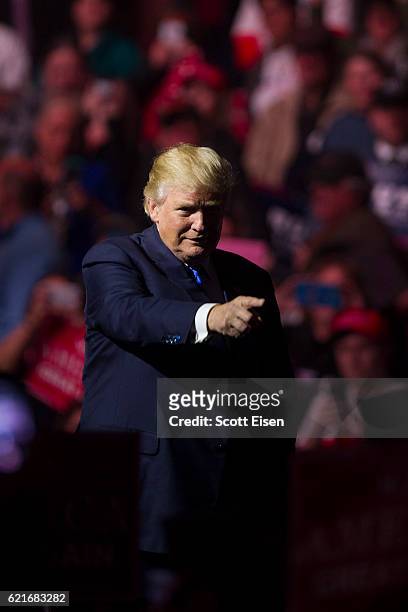 Republican presidential candidate Donald Trump points to supporters at the end of his rally at the SNHU Arena on November 7, 2016 in Manchester, New...