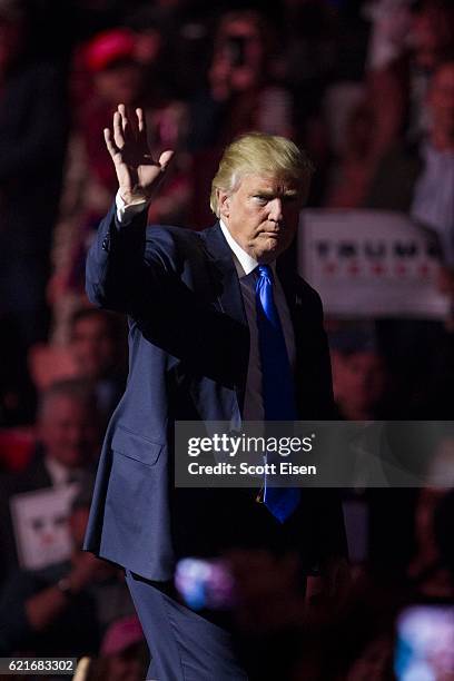 Republican presidential candidate Donald Trump waves to supports at the end of his rally at the SNHU Arena on November 7, 2016 in Manchester, New...