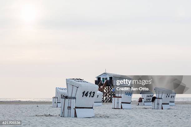 pile dwelling and beach chairs in st. peter-ording, germany - st peter ording stock pictures, royalty-free photos & images