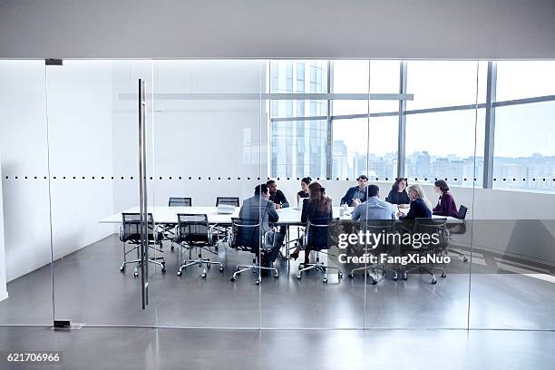 colleagues at business meeting in conference room - workshop table stock pictures, royalty-free photos & images