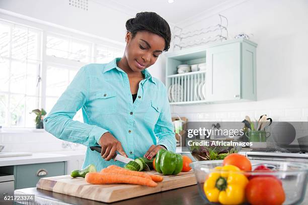 african female cooking up a storm. - meal plan stock pictures, royalty-free photos & images