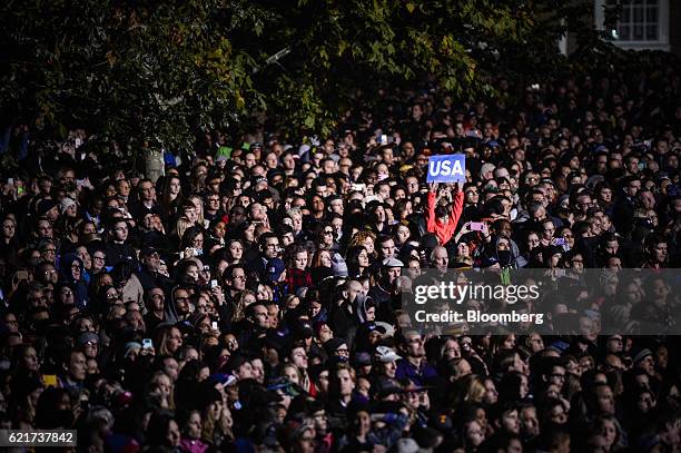 An attendee holds up a "USA" sign in the crowd during a campaign event for Hillary Clinton, 2016 Democratic presidential nominee, not pictured, in...